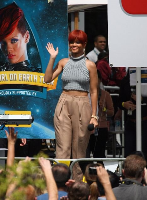 Smile for the fans: Singer Rihanna waves to the crowd outside the Optus Headquarters in Sydney last week